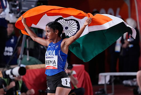 India's Seema carries her country's flag as she celebrates after competing in the women's 10,000m final at the Asian Games in Nagoya, Japan, Thursday, Sept. 24, 2026. 