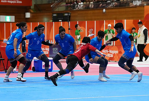 Iran's Atena Madadi reaches to tag an Indian player during the women's kabaddi final at the Asian Games in Tokai City, Japan, Saturday, Sept. 26, 2026. 