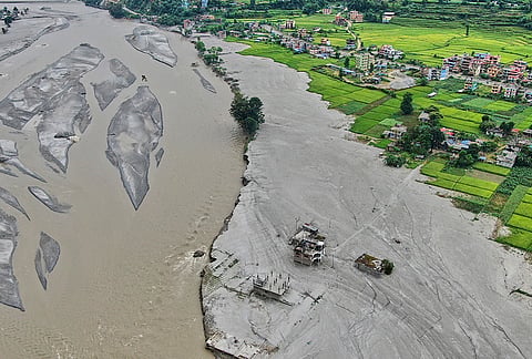 Farmland covered in mud and houses damaged by flash floods are seen along the banks of the Trishuli River in Galchi, in Nepal's Nuwakot district, Wednesday, Sept. 23, 2026.