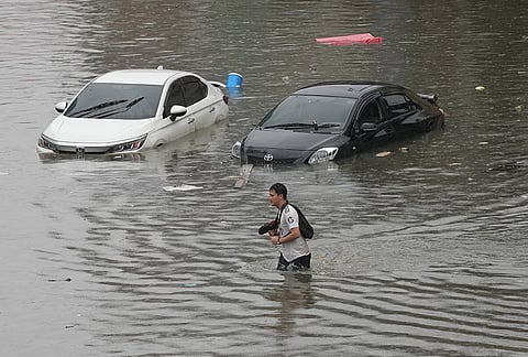 Man wades through floodwaters after heavy rain in Bangkok, Thailand, Saturday, Sept. 26, 2026. 