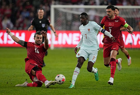 Turkey's Abdülkerim Bardakcı clears the ball in front of France's Ousmane Dembele during the UEFA Nations League soccer match between Turkey and France in Izmit, Turkey, Friday, Sept. 25, 2026. 