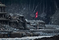 | Photo: AP/Niranjan Shrestha : A Nepalese flag flies amid houses damaged by flash floods along the banks of the Trishuli River in Dunge, in Nepal's Nuwakot district, Wednesday, Sept. 23, 2026. 
