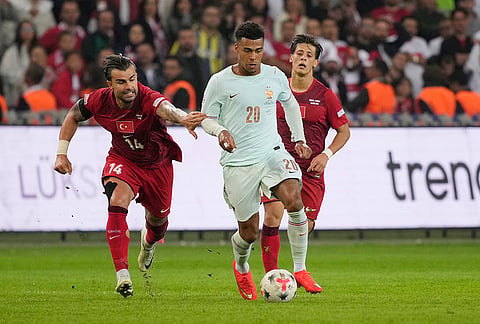 Turkey's Abdülkerim Bardakcı holds France's Desire Doue during the UEFA Nations League soccer match between Turkey and France in Izmit, Turkey, Friday, Sept. 25, 2026. 