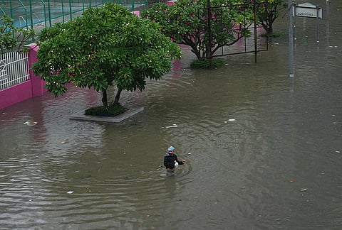 Man wades through floodwaters after heavy rain in Bangkok, Thailand, Saturday, Sept. 26, 2026. 