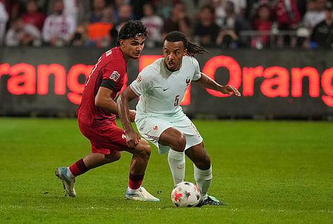 France's Jules Kounde in acttion in front of Turkey's Can Uzun during the UEFA Nations League soccer match between Turkey and France in Izmit, Turkey, Friday, Sept. 25, 2026. 
