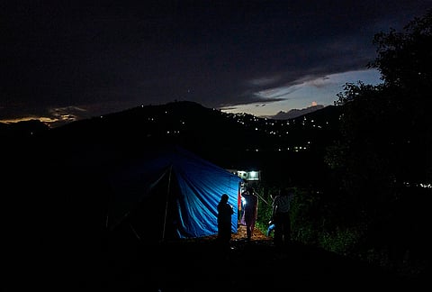 A flood affected woman stands outside temporary shelters for survivors in Nuwakot, Nepal, Tuesday, Sept. 22, 2026. 
