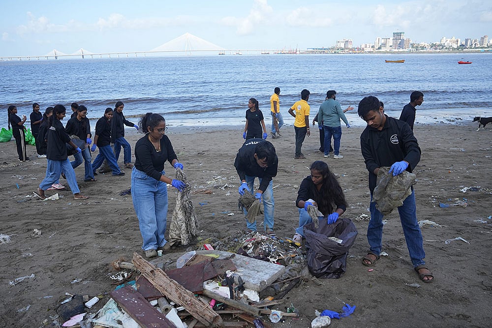 Students clean a beach in Mumbai
