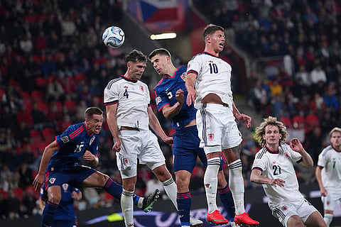 Croatia's Luka Vuskovic, center, jumps for the ball between Czechia's Robin Hranac and Adam Hlozek, right, during the Nations League soccer match between Czechia and Croatia in Prague.