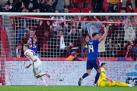 Czechia's Matej Radosta, left, runs celebrating after scoring a goal later disallowed for offside during the Nations League soccer match between Czechia and Croatia in Prague.
