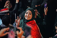 | Photo: AP/Abdulnasser Alseddik : A woman flashes V sign as she celebrates the 64th anniversary of the September 26 Revolution in Taiz, Yemen, Friday, Sept. 25, 2026.