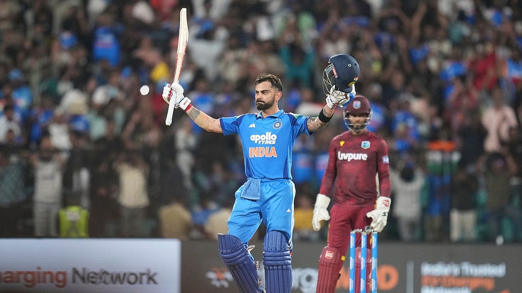 India's Virat Kohli celebrates his century during the first one day international cricket match between India and West Indies in Thiruvananthapuram. - Rafiq Maqbool/AP Photo