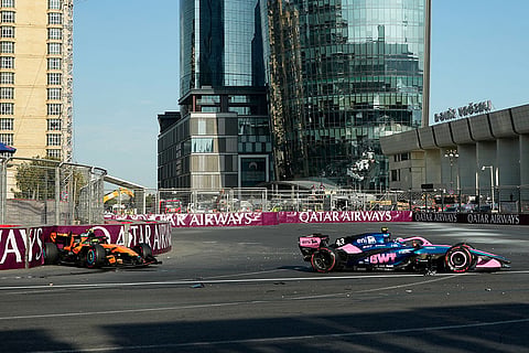 McLaren driver Lando Norris of Britain and Alpine driver Franco Colapinto of Argentina sit in their cars after crashing during the Azerbaijan F1 Grand Prix race, in Baku, Azerbaijan, Saturday, Sept. 26, 2026.