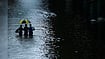 Reuters :  People wade through a flooded street during heavy rain in Bangkok