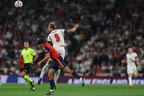 England's Harry Kane, leaps to head the ball under pressure from Spain's Paul Cubarsi during the Nations League Soccer match between England and Spain in London, Saturday, Sept. 26, 2026.