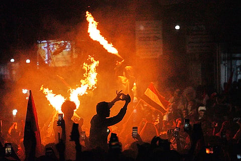 Yemenis wave national flags and light fires as they celebrate the 64th anniversary of the September 26 Revolution in Taiz, Yemen, Friday, Sept. 25, 2026.