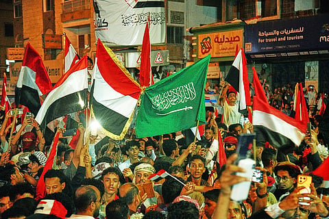 Yemenis wave national and Saudi flags as they celebrate the 64th anniversary of the September 26 Revolution in Taiz, Yemen, Friday, Sept. 25, 2026.
