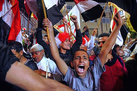 Yemenis wave national flags as they celebrate the 64th anniversary of the September 26 Revolution in government-controlled Taiz, Yemen, Friday, Sept. 25, 2026.
