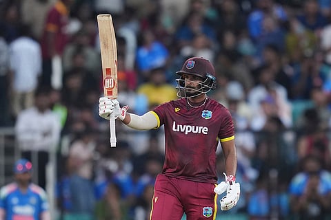 West Indies' Amir Jangoo celebrates his fifty runs during the first one day international cricket match between India and West Indies in Thiruvananthapuram, India.