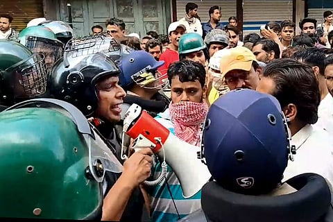 Security personnel interact with people following stone-pelting incidents during protests against the proposed removal of a portion of the 'Shahi Masjid' for road widening, in Ujjain, Madhya Pradesh, Monday, Sept. 28, 2026.