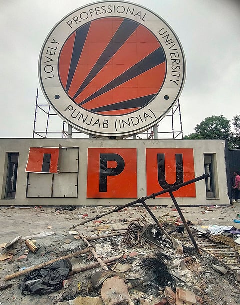 Debris and charred remains lie scattered on the ground after a protest by students at the Lovely Professional University (LPU) campus, in Phagwara, Punjab, Sunday, Sept. 27, 2026. 
