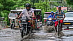 | Photo; PTI : Commuters move through a waterlogged road during monsoon rain, in Prayagraj, Uttar Pradesh.