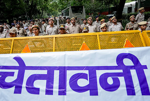 Police personnel stand guard behind barricades during the Indian Youth Congress (IYC) protest demonstration near the Election Commission of India (ECI) headquarters, in New Delhi, Monday, Sept. 28, 2026. 
