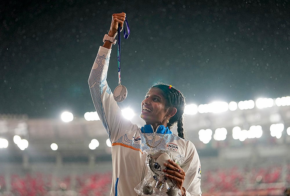 India's Ancy Sojan Edappilly poses on the podium after securing the silver medal in the women's long jump event during the ongoing Asian Games, in Nagoya, Japan, Monday, Sept. 28, 2026.  - | Photo: PTI/Arun Sharma
