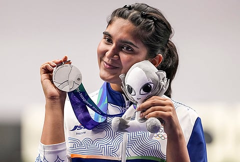 India's Esha Singh poses with her silver medal won in the women's 25m pistol event during the ongoing 20th Asian Games, in Nagoya, Japan, Monday, Sept. 28, 2026.
