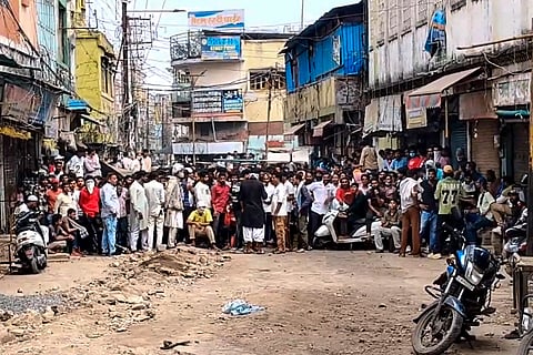 People gather following stone-pelting incidents during protests against the proposed removal of a portion of the 'Shahi Masjid' for road widening, in Ujjain, Madhya Pradesh, Monday, Sept. 28, 2026.