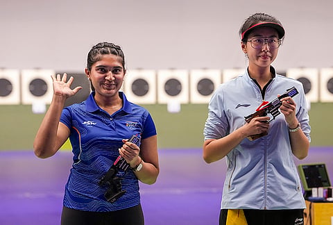 India's Esha Singh, left, greets after securing a silver medal during the women's 25m pistol event in the ongoing 20th Asian Games, at the Aichi Prefectural Shooting Range in Nagoya, Aichi Prefecture, Japan, Monday, Sept. 28, 2026.