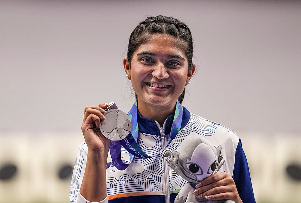 India's Esha Singh poses with her silver medal won in the women's 25m pistol event during the ongoing 20th Asian Games, in Nagoya, Japan, Monday, Sept. 28, 2026.  - | Photo: PTI/Atul Yadav 