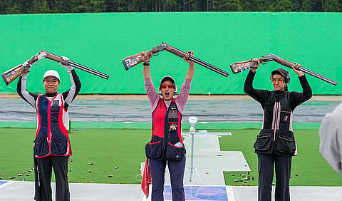 India's Neeru Dhanda, centre, after winning the gold medal in the women's trap shooting individual event during the ongoing 20th Asian Games, in Nagoya, Japan, Tuesday, Sept. 29, 2026. China's Sun Yunong, left, and Kuwait's Hajar Abdulmalik are also seen. 