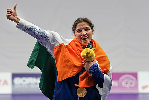 India's Neeru Dhanda holds the event mascot during the victory ceremony for the women's trap shooting individual event at the 20th Asian Games 2026, in Nagoya, Japan, Tuesday, Sept. 29, 2026. 