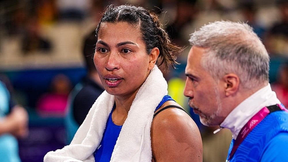 India's Lovlina Borgohain, in blue, with her coach after losing to Australia's Emma-Sue Greentree in the women's 75kg final boxing bout at the 23rd Commonwealth Games (CWG), in Glasgow, Scotland. - | Photo: PTI/Ravi Choudhary