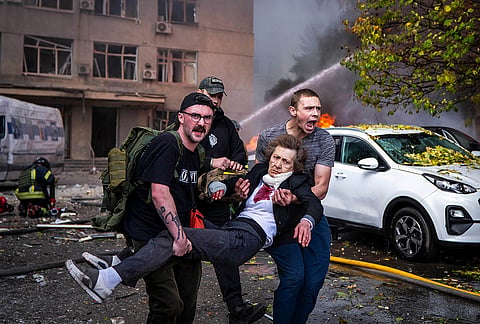 People carry an injured woman into an ambulance after a Russian drone strike in Kyiv, Ukraine, Monday, Sept. 28, 2026. 
