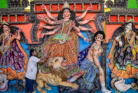 An artist prepares idols of Goddess Durga ahead of the Durga Puja festival, in Nadia, West Bengal.