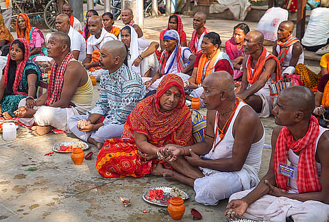 People perform rituals on the banks of the Ganga river on the third day of 'Pitra Paksha', in Varanasi, Uttar Pradesh.