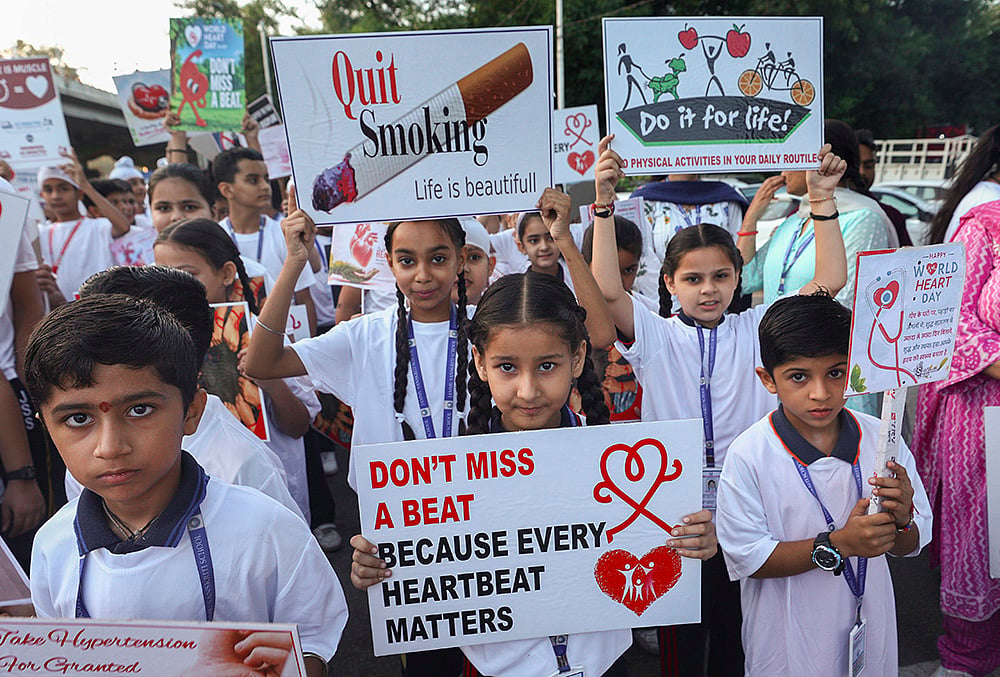 Students hold placards as they participate in a walkathon to mark World Heart Day, in Jammu, Jammu and Kashmir. - | Photo: PTI
