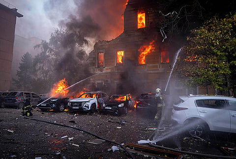 Rescue workers put out a fire at the National Academy of Sciences building damaged after a Russian drone strike in the center of Kyiv, Ukraine, Monday, Sept. 28, 2026. 