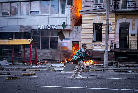 A man runs in front of a hospital damaged after a Russian drone strike in central Kyiv, Ukraine, Monday, Sept. 28, 2026. 