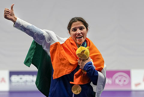 India's Neeru Dhanda holds the event mascot during the victory ceremony for the women's trap shooting individual event at the 20th Asian Games 2026, in Nagoya, Japan.