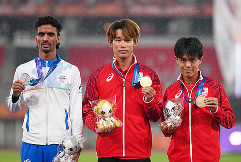 Gold medalist Japan's Kazuto Iizawa, center, stands on the podium with silver medalist, India's Gulveer Singh, left, and bronze medalist Japan's Nagiya Mori following the men's 1500m at the Asian Games in Nagoya, Japan, Tuesday, Sept. 29, 2026. 