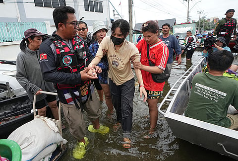 Rescuers evacuate a patient from a flooded area to a safer place in Bangkok, Thailand, Monday, Sept. 28, 2026. 