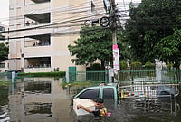 Thailand Underwater: Extreme Weather Floods Cities And Communities | Photo: AP/Sakchai Lalit : A man wades through a flooded street after heavy rain in Bangkok, Thailand, Monday, Sept. 28, 2026.