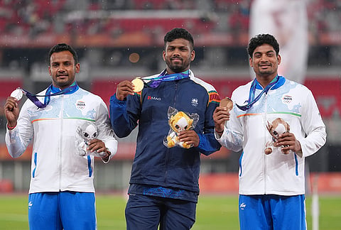 Gold medalist, Rumesh Pathirage of Sri Lanka, centre, silver medalist, Yashvir Singh of India, left, and bronze medalist Rohit Yadav of India pose on the podium following the men's javelin throw at the Asian Games in Nagoya, Japan, Tuesday, Sept. 29, 2026. 