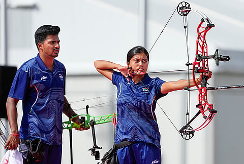 India's Chikitha Taniparthi, right, and Sahil Jadhav compete in the compound mixed team archery gold medal match against Korea during the 20th Asian Games, in Nagoya, Japan.