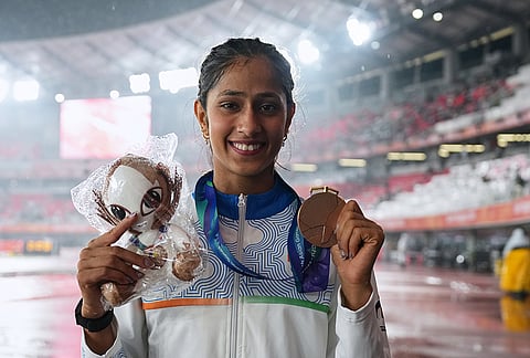 Bronze medalist Pooja of India poses with her medal following the women's high jump final at the Asian Games in Nagoya, Japan, Tuesday, Sept. 29, 2026. 
