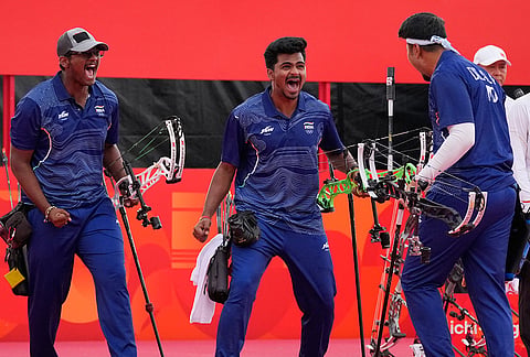 India's Sahil Rajesh Jadhav, center, Kushal Dalal, right, and Ganesh Mani Ratnam Thirumuru, left, celebrate after winning over China during the compound men's team final in archery at the Asian Games in Okazaki, Japan, Wednesday, Sept. 30, 2026. 