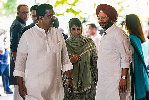 Congress leader Gurdeep Singh Sappal, right, and PDP chief Mehbooba Mufti arrive for the INDIA bloc meeting to finalise an action plan for a joint agitation over alleged irregularities in the SIR exercise and to press for CEC Gyanesh Kumar's resignation, in New Delhi.