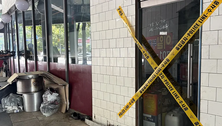 Yellow police tape crosses the locked entrance of the Chinese restaurant "Xi Jinping" after a reported break-in and property damage in Seongnam - | LEE AH-MI